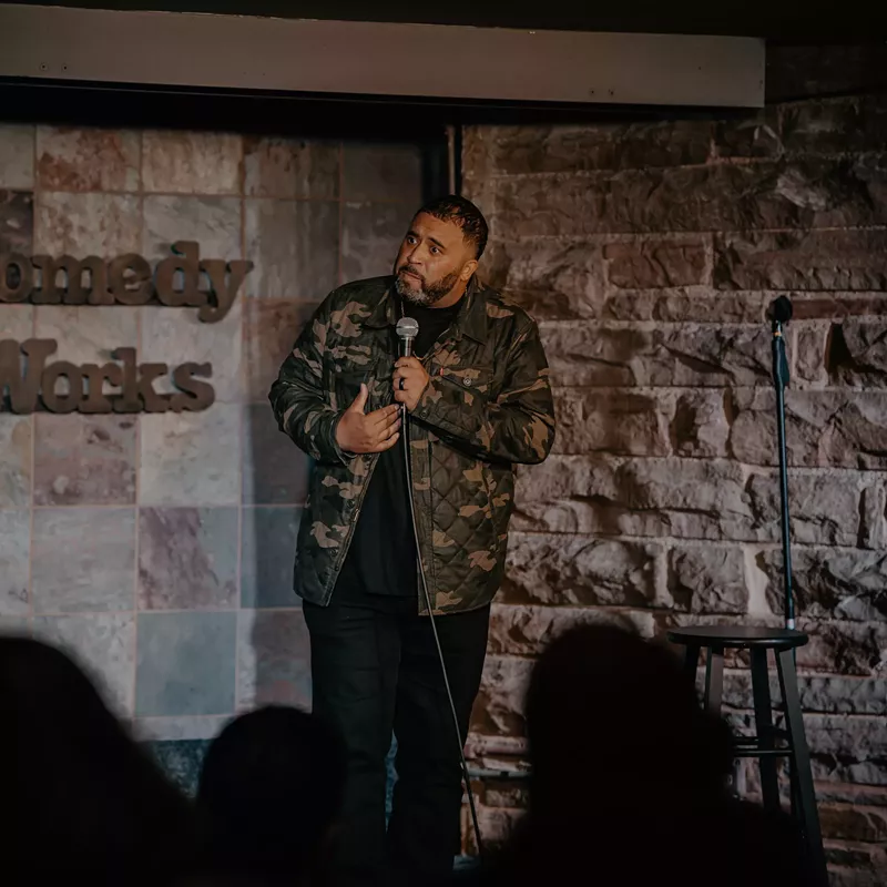 Image: A comedian performs on stage at Comedy Works.