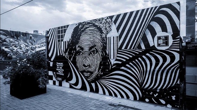 A black and white street art mural in Denver by muralist A.L. Grime