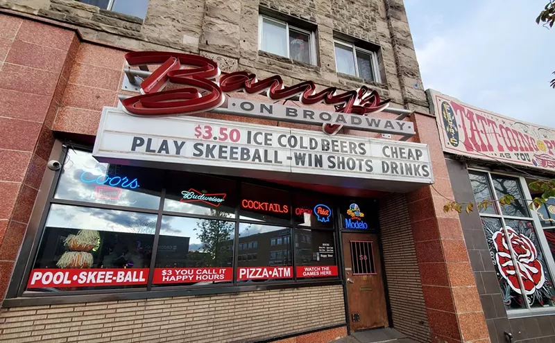 Image: a sign hanging over the entrance to a bar