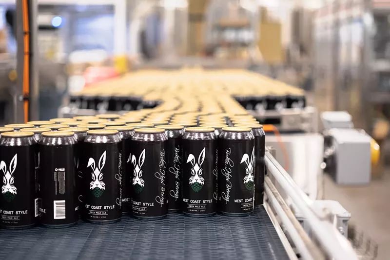 Image: Cans of beer with dark label and rabbit.