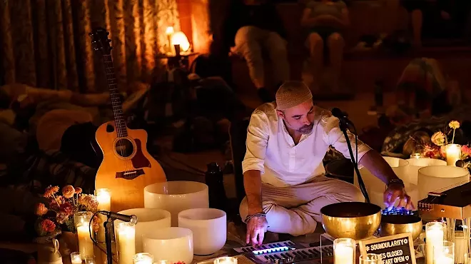 man playing singing bowls