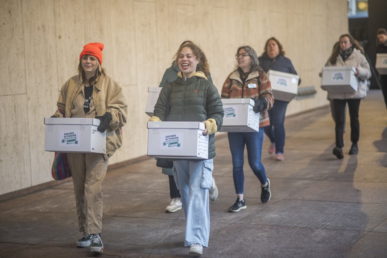 Members of Coloradans for Protecting Reproductive Freedom turn in 99 boxes of petition signatures in support of an abortion rights ballot measure proposal.