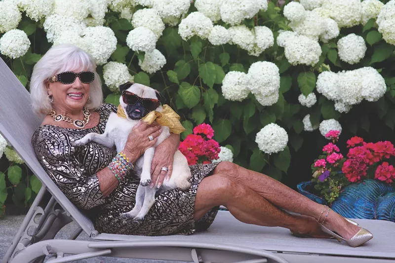 Image: woman with her pug on a chiase lounge