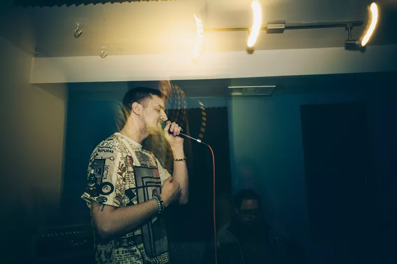 Image: man rapping into microphone