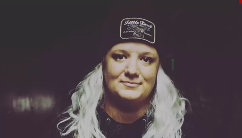 Image: blonde woman wearing black hat