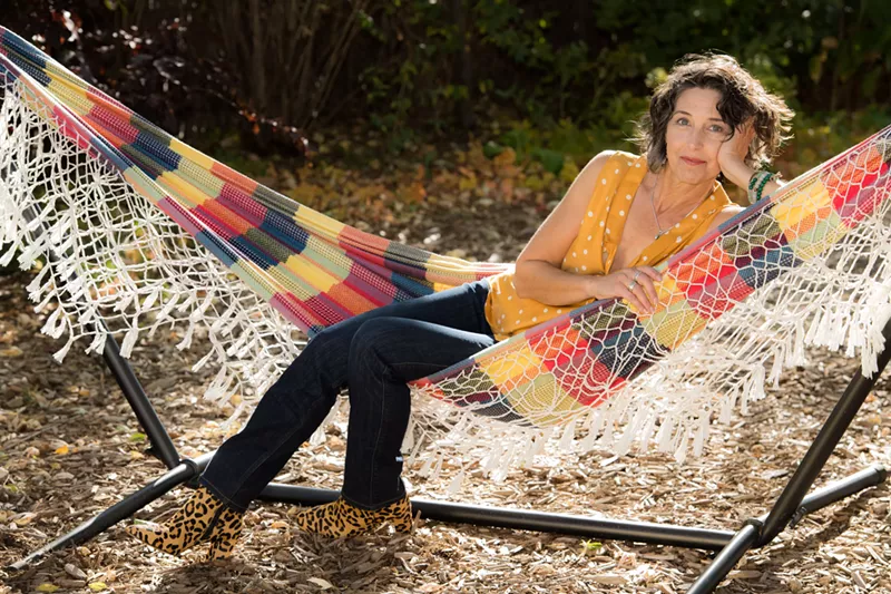 Image: Life coach and Colorado author Amrita Rose reclines in a plaid hammock.