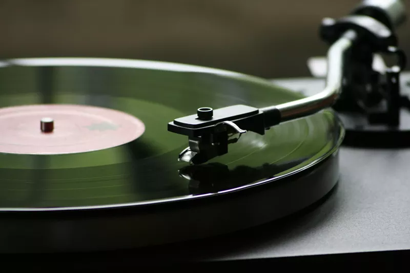 Image: A record player playing a vinyl