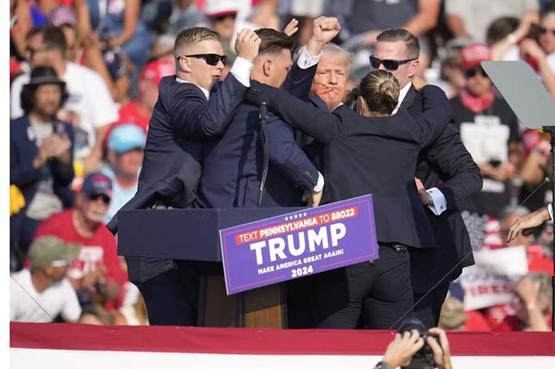 Former President Donald Trump is helped off the stage at a campaign event on July 13.