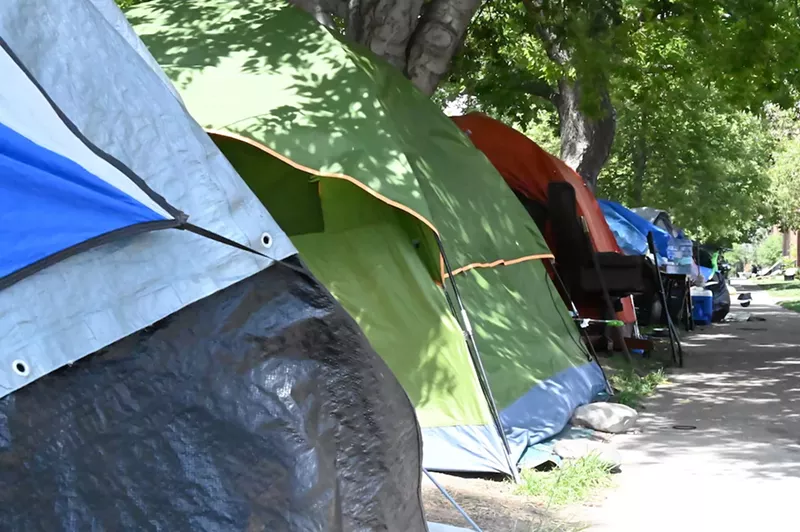 Image: Tents line the sidewalk on the east side of Logan Street between 17th and 18th Avenue.