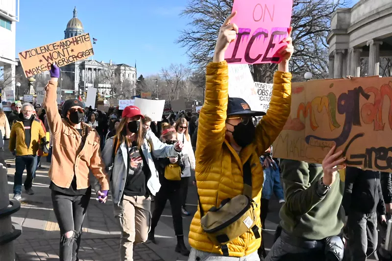 Image: Protesters march down Colfax Avenue.