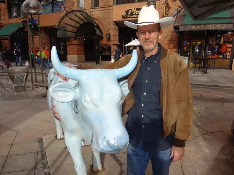 Image: man with cow sculpture