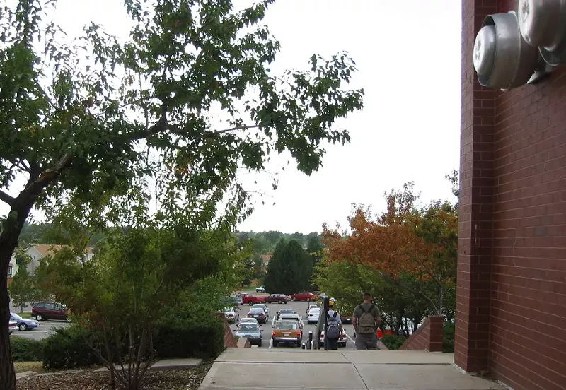Image: high school students walk down the stairs outside