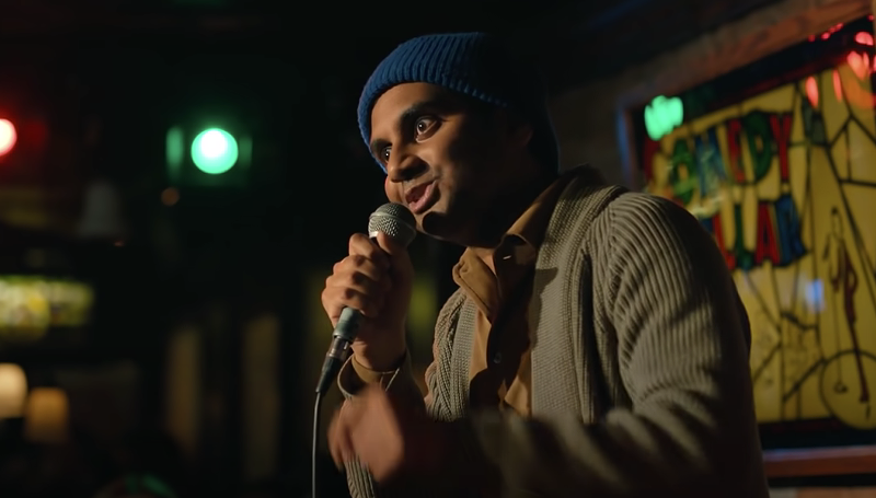 Image: man in blue beanie talking into a microphone