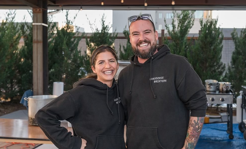 Image: woman and man in black hoodies