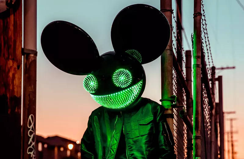 Image: man deejaying in mouse mask