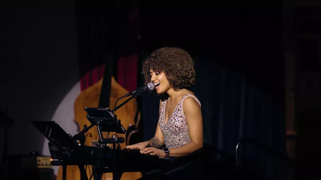 Singer Dzirae Gold performs at a piano