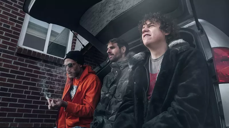 Image: three men smoking a joint