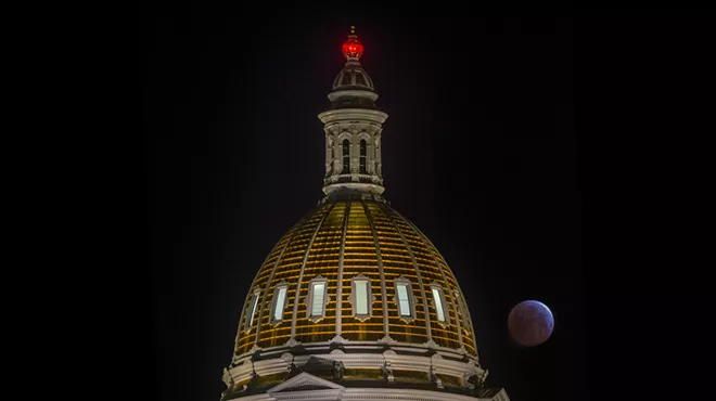 Red moon behind Colorado State Capitol dome