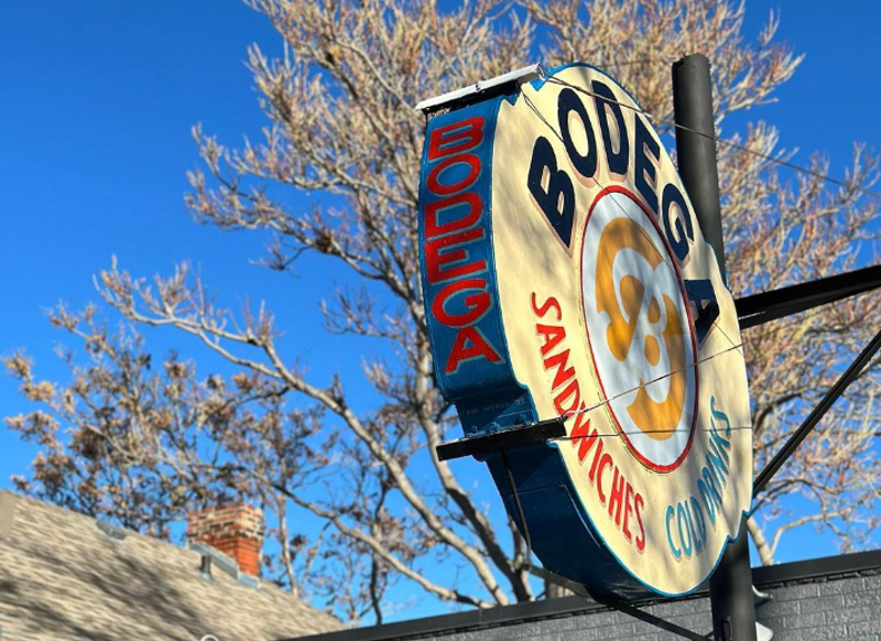 Image: a round sign that says "bodega"