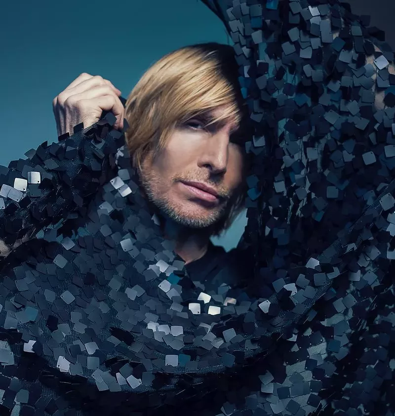 Image: A man in a black sparkly outfit