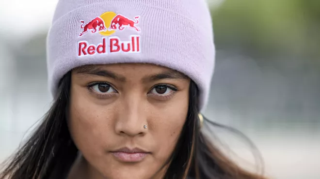 A woman wearing a Red Bull beanie.