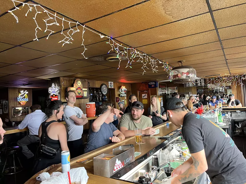 Image: patrons seated at a bar