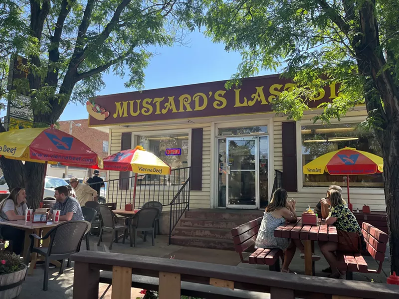 Image: tables with umbrellas in front of a restaurant