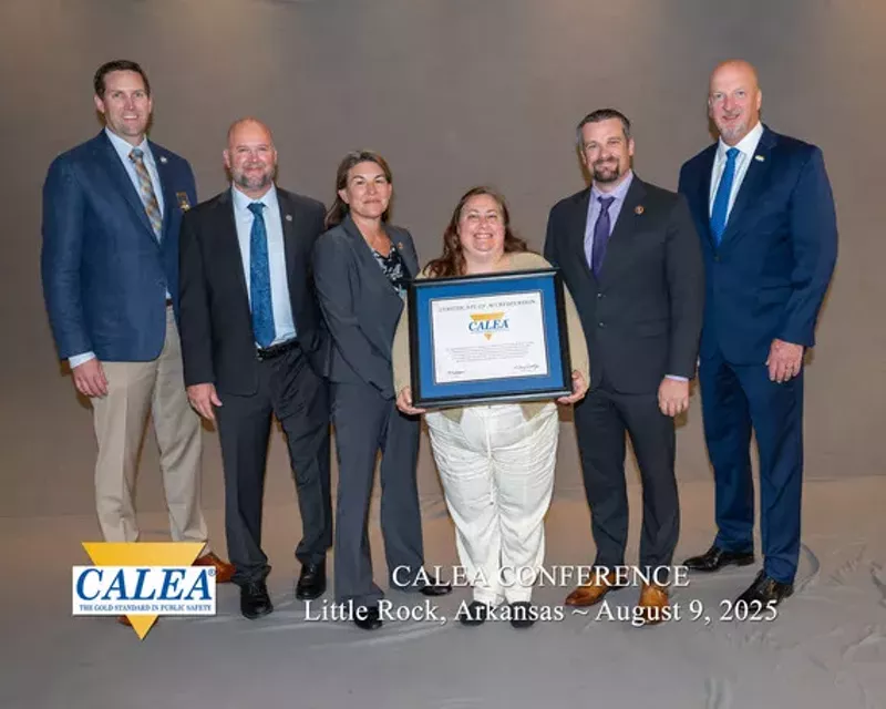 Image: Representatives of the CALEA and CBI pose in celebration of the agency's fourth consecutive accreditation.