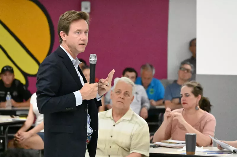 Image: A person speaks to a crowd.
