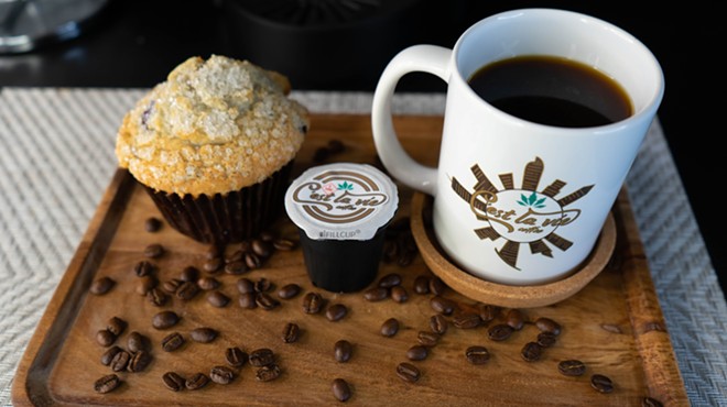 Weed-infused coffee pods, coffee beans, a cup of THC coffee and a muffin.
