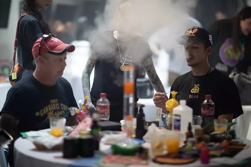 Image: Men smoke weed at a cannabis party in Denver