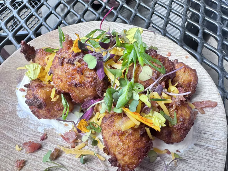 Image: tater tots garnished with greens