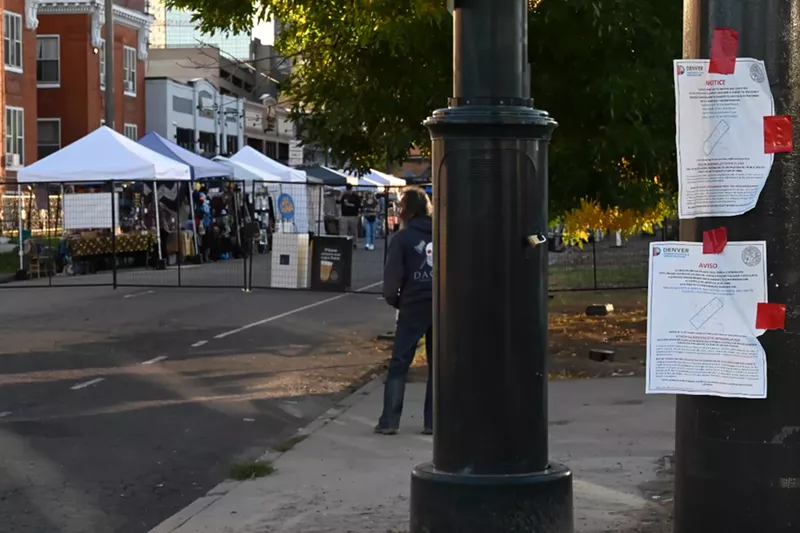 Image: A homeless man stands in area that's a permanently posted cleanup area.