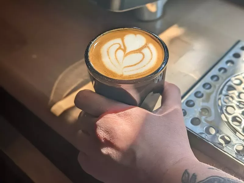 Image: hand holding a latte