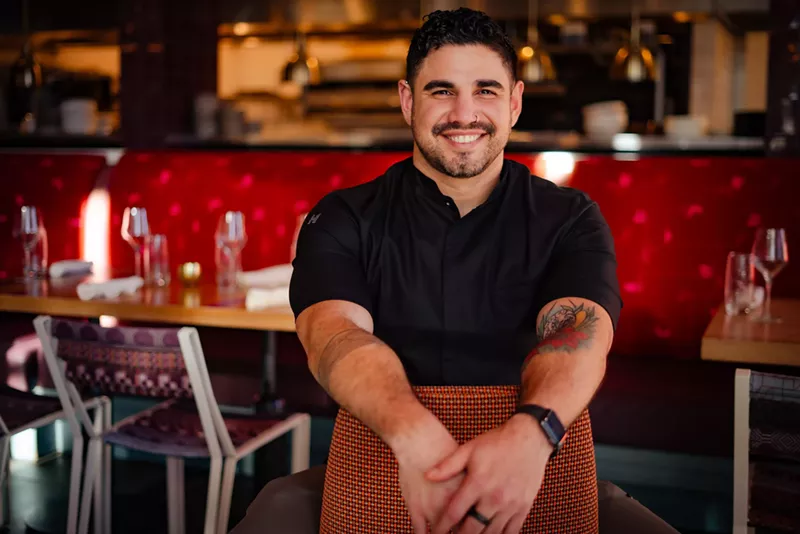 Image: a man in a black chef's coat