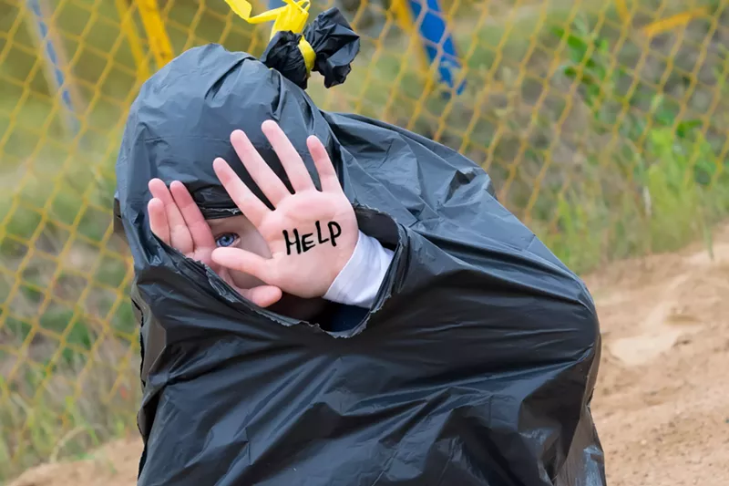 Image: child in trash bag