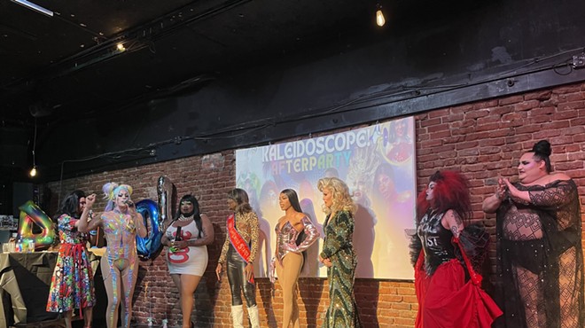 drag queens stand on stage