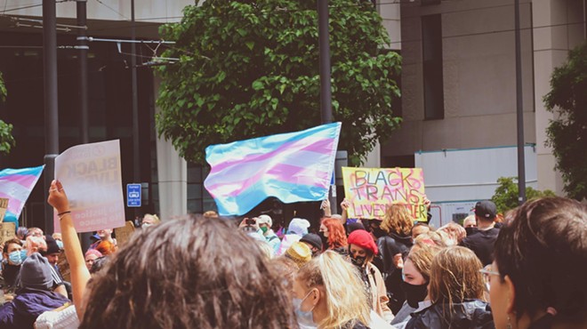 Transgender flag held up during protest.