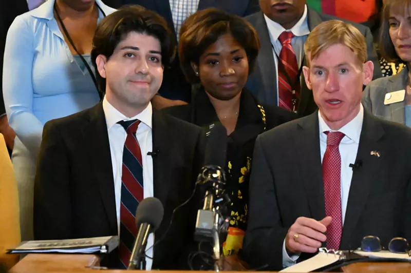 Image: Two people speak at the Capitol.