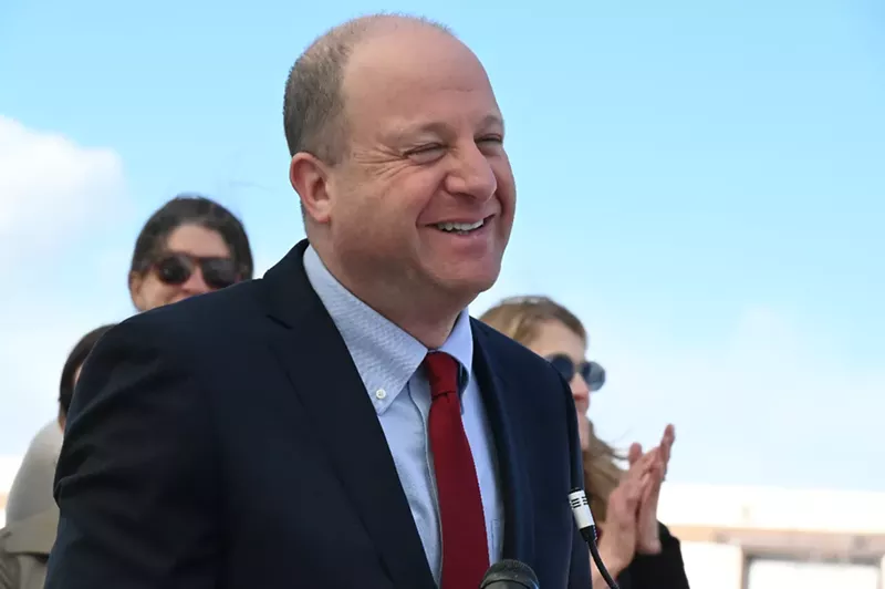 Image: The governor smiles outside.