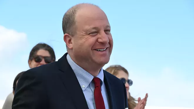 The governor smiles outside.
