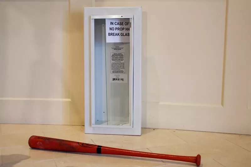 Image: A bat and emergency case used by Governor Jared Polis to illustrate his new plans for property tax relief in Colorado.