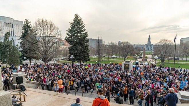 A crowd gathered on the steps of the state capitol building.