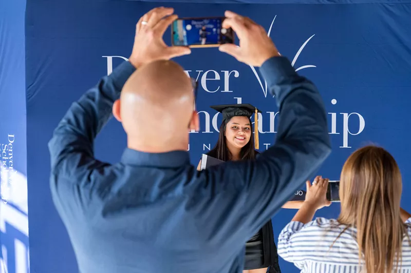 Image: Man taking photograph of graduate