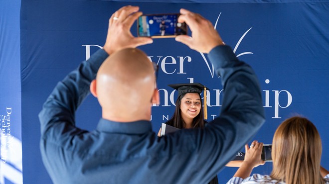 Man taking photograph of graduate