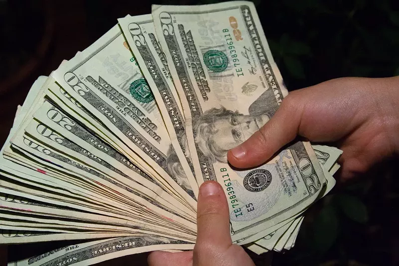 Image: Holding a lot of $20 bills