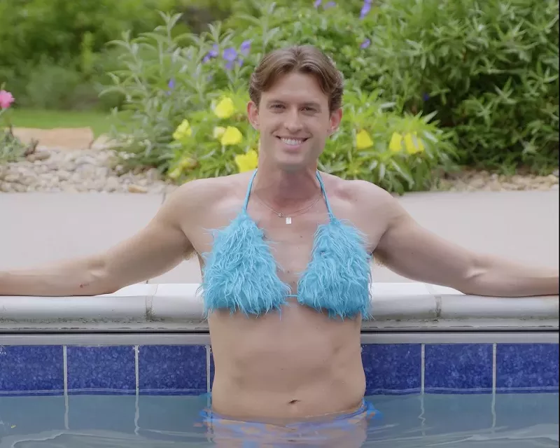 Image: Connor Cole wears a fuzzy blue bikini set while in a pool, just like character Elle Woods did in Legally Blonde.
