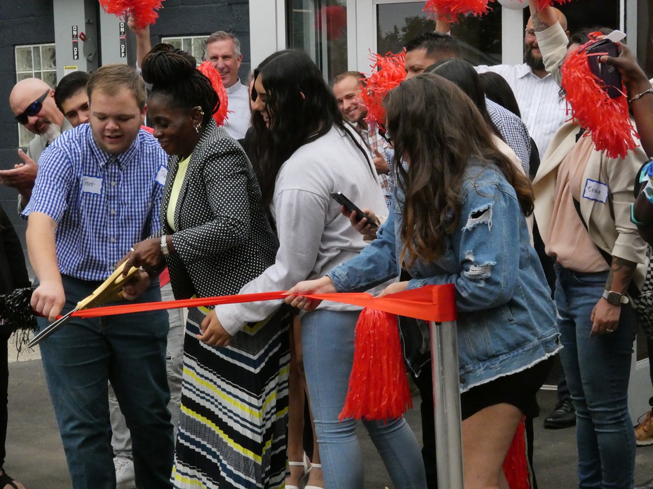 Students and staff cut the ribbon at the CrossPurpose opening.