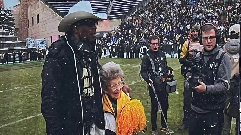 Image: Deion Sanders, aka Coach Prime, and CU Boulder super fan Peggy Coppom, as seen on the Folsom Field Jumbotron.