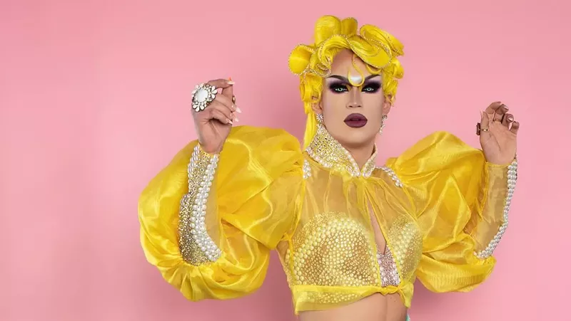 Image: drag queen in gold top and wig